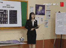 a woman in a suit is giving a presentation in front of a board that says skill aktif dan pasif