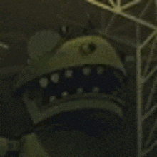 a close up of a cartoon character 's face with a glowing orange eye .