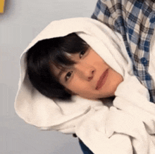 a close up of a person wearing a hooded sweatshirt .