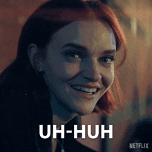 a close up of a woman 's face with the words uh-huh on the bottom