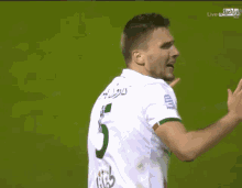 a soccer player with the number 5 on the back of his shirt