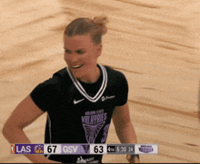a female basketball player wearing a shirt that says valkyries