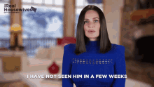a woman in a blue sweater with the words i have not seen him in a few weeks below her