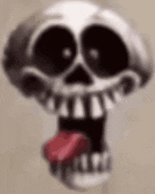 a close up of a cartoon skull with its tongue out .
