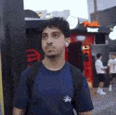 a young man wearing a blue stussy t-shirt