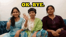 three women sitting on a couch with the words ok bye written above them