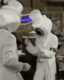 a blurred image of a group of people in white suits