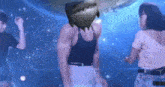 a man and a woman are dancing in a club with a shark on his head .
