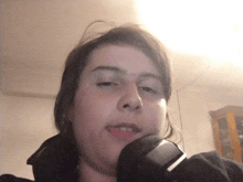a woman with a watch on her wrist looks at the camera with her eyes closed