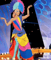 a woman in a colorful costume is dancing on a stage with a watermark that says t4yce tumblr
