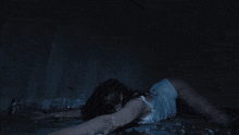 a woman is laying on her back with her head on her shoulder