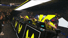 a group of people are sitting in front of computer monitors with a sign that says ' a ' on it