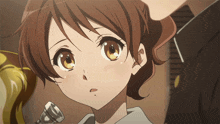a girl with brown hair is holding a trumpet