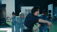 a group of people are dancing in front of a sign that says skywavedfs