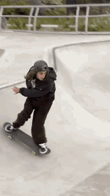 a person is riding a skateboard on a ramp with a hoodie that says ' a ' on it