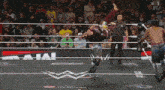 wrestlers in a ring with a sign that says w live