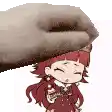 a hand is holding a little girl in a red dress on a white background .