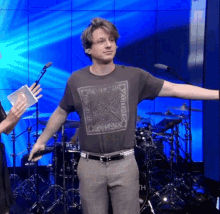 a man with his arms outstretched is wearing a t-shirt that says " o'reilly band "