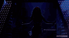 a woman is dancing on a stage with the hashtag premiosjuventud