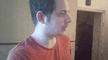 a man wearing a red shirt that says ' milano ' on it