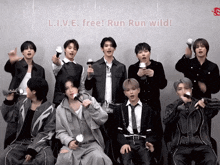 a group of young men are standing in front of a wall that says l.i.v.e. free! run run wild!