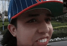 a close up of a man wearing a baseball cap .