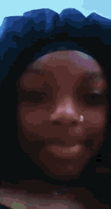 a close up of a woman with a nose ring on her nose .