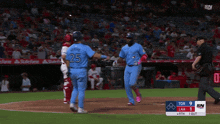 a blue jays player wearing number 25 is being congratulated by another player