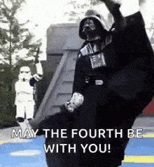 darth vader is dancing in front of a stormtrooper and saying `` may the fourth be with you '' .