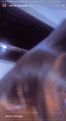 a blurred image of a person 's face with a send message button in the corner