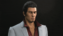 a man with a beard wearing a grey suit and red shirt