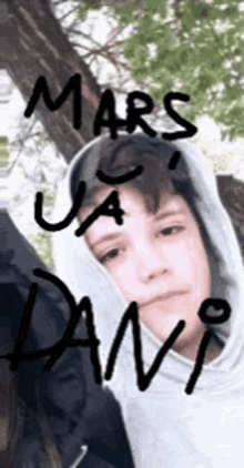a boy wearing a hoodie with the name mars written on it .