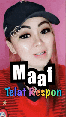 a woman wearing a hat and a red shirt says maaf