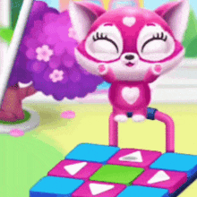 a pink cat is standing on top of a colorful block .