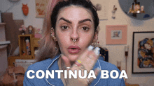 a woman in a blue shirt says continua boa in white letters