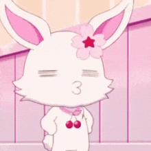 a white rabbit with a pink flower on its head is blowing a kiss