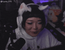 a woman wearing cat ears and a white hoodie
