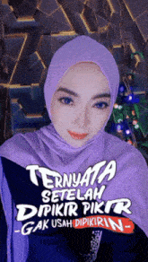 a woman wearing a purple hijab with the words " ternyata setelah dipikir pikir -gak usah dipikirin "