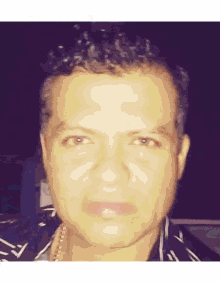 a man with curly hair is wearing a black and white shirt