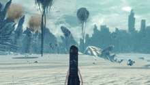a person standing in a snowy field with a snowboard