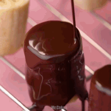 chocolate is being poured on a marshmallow with the words mr.cakes visible