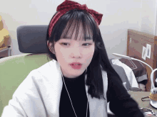a girl wearing headphones and a headband with a bow on it