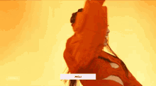 a woman in a red jacket is smiling and dancing