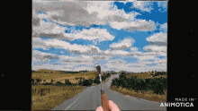 a painting of a road with clouds is made in animatica