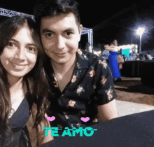 a man and a woman are posing for a picture with the word te amo written on the bottom