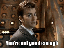 a man in a suit is saying you 're not good enough