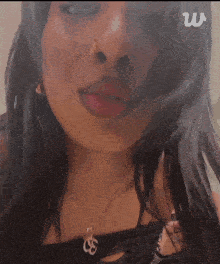 a close up of a woman 's face with the letter w visible