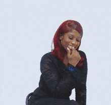 a woman with red hair is wearing a black lace dress