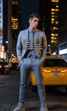 a man in a suit and tie is standing in front of a yellow taxi