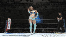 a woman in a wrestling ring with a sign that says nft lab on it
